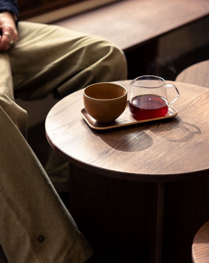Table ronde en bois avec service de thé dans coffee shop minimaliste